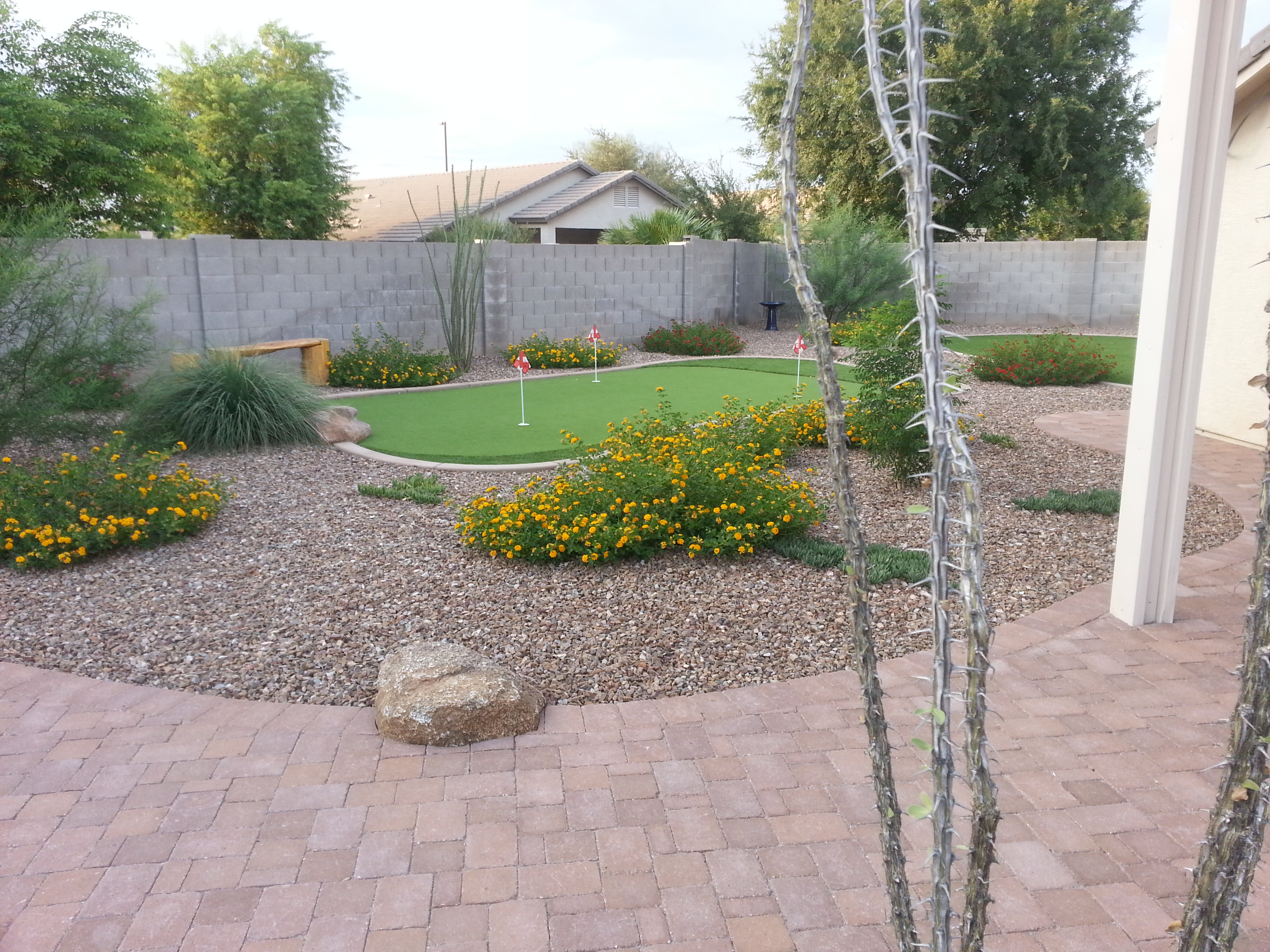 gorgeous paver patio with decorative granite and beautiful plants for a lovely back yard,